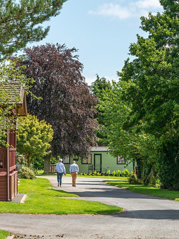 Luxury self-catering holiday lodge with fishing lake. Village location. Park photo