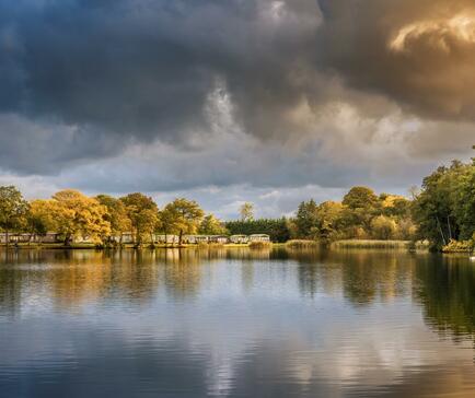 Autumn across the lake at Pearl Lake Country Holiday Park