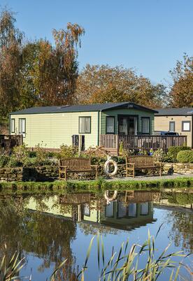 Autumn colours across the lake at Arrow Bank Country Holiday Park, Herefordshire