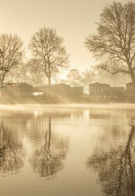 Sunrise over the lake and the lakeside holiday homes at Pearl Lake Herefordshire