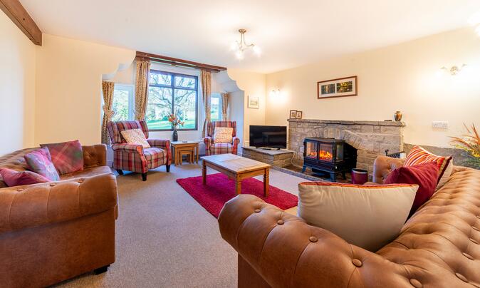 Self-actering holiday cottage with golf course - lounge photo